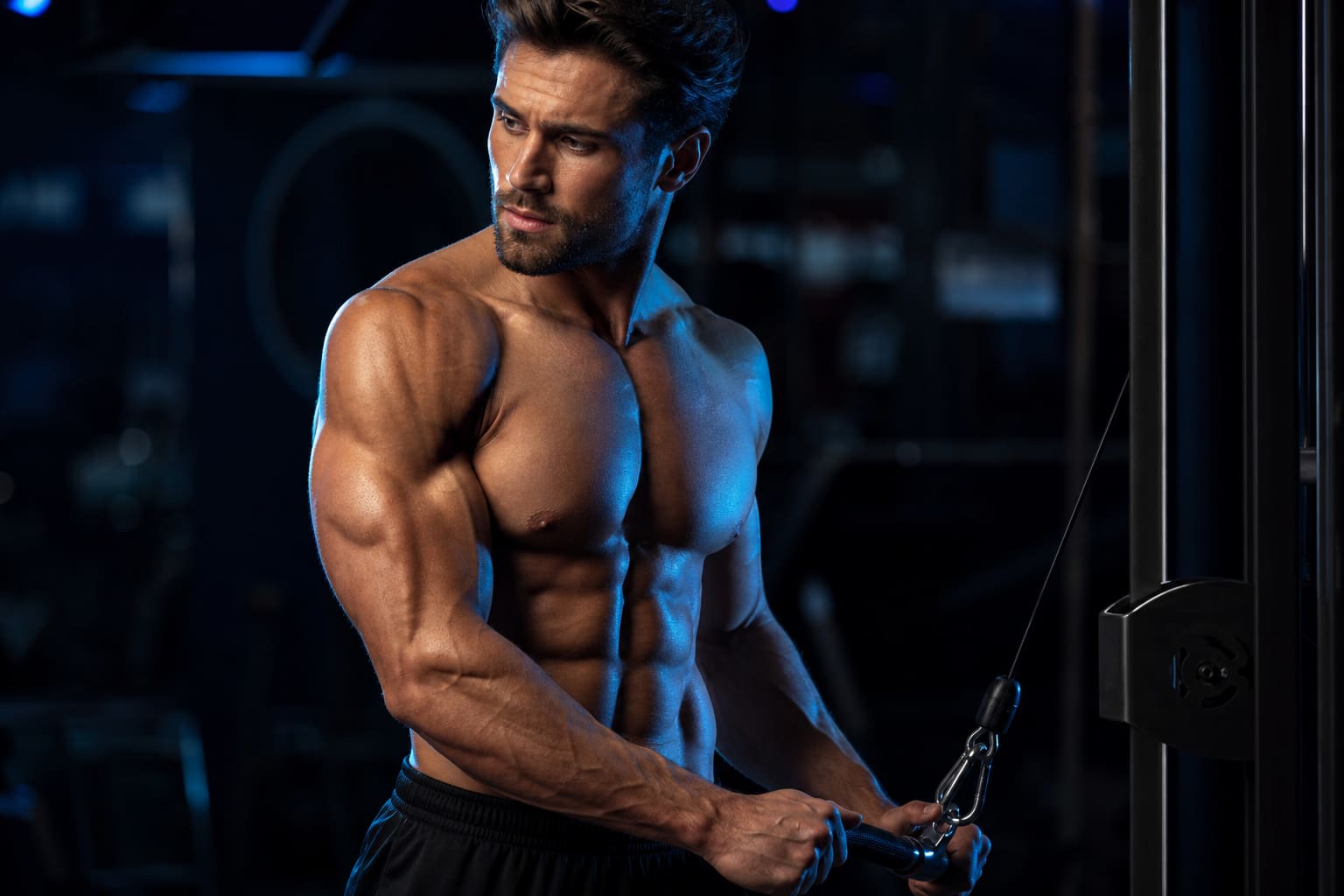 Bodybuilder training on a cable machine